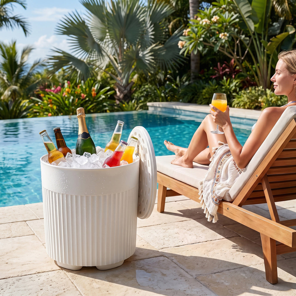 The white 3-in-1 outdoor cooler side table features a fluted design and holds 6.2 gallons for drinks by the pool.