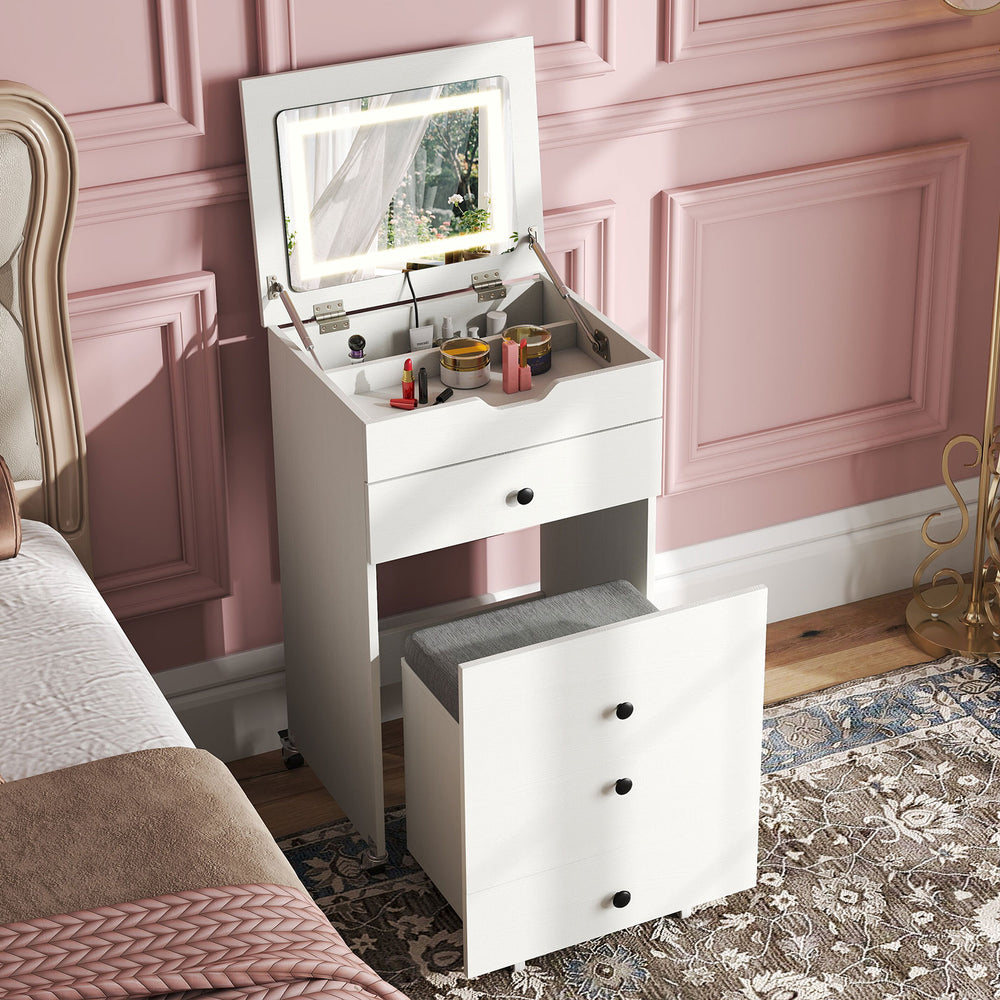 Small white vanity desk set with flip-top mirror, lights, drawers, and stool, perfect for small rooms and apartments.