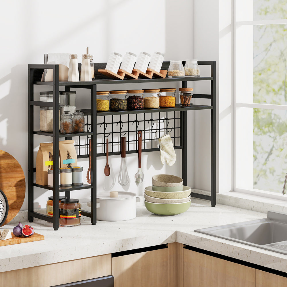 4-tier black desk shelf with metal grid panel and hooks, perfect for organizing kitchen essentials and decorations.