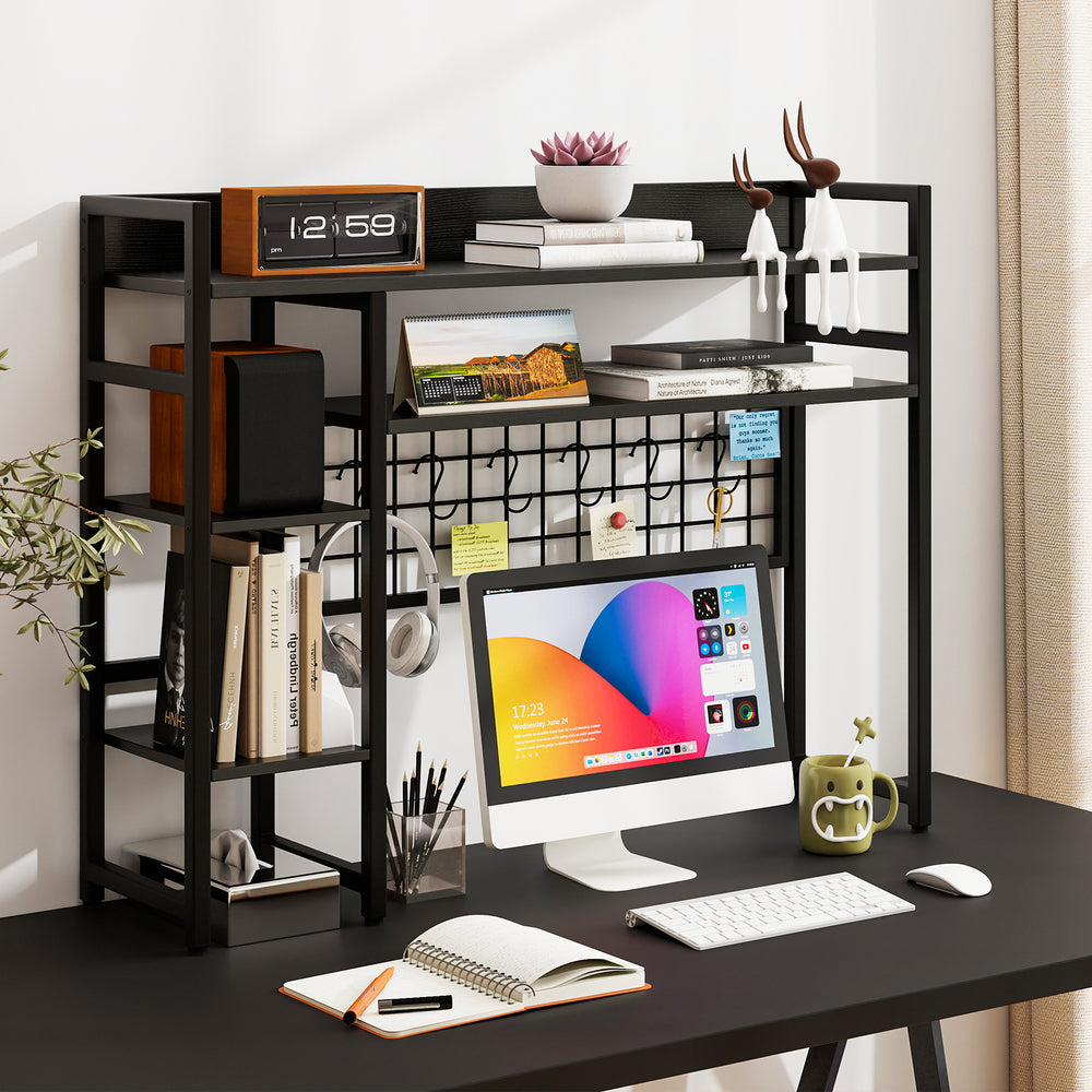 4-tier black desk shelf with metal grid panel and hooks, ideal for organizing books and decor on a computer desk.