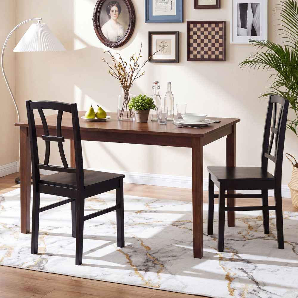 Two black dining chairs with cross backrests and rubber wood frames, perfect for kitchen or dining room use.
