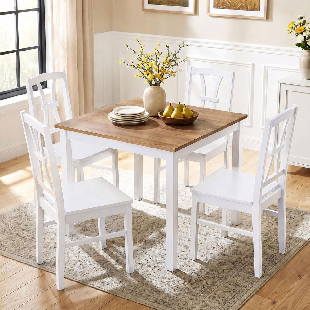 Dining table set featuring four white rubber wood chairs with cross backrests, perfect for kitchen or dining room use.