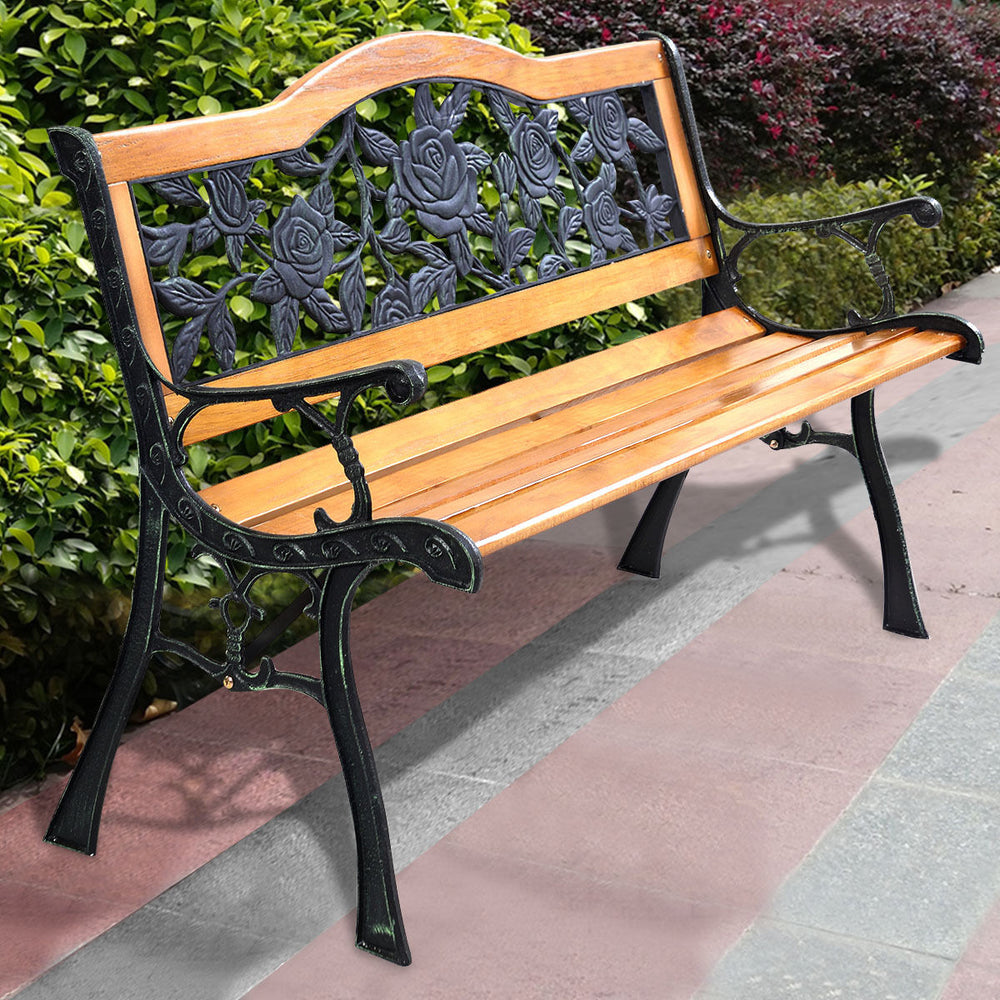 Garden bench chair with wooden seat and iron armrest, featuring a floral backrest design for outdoor seating.