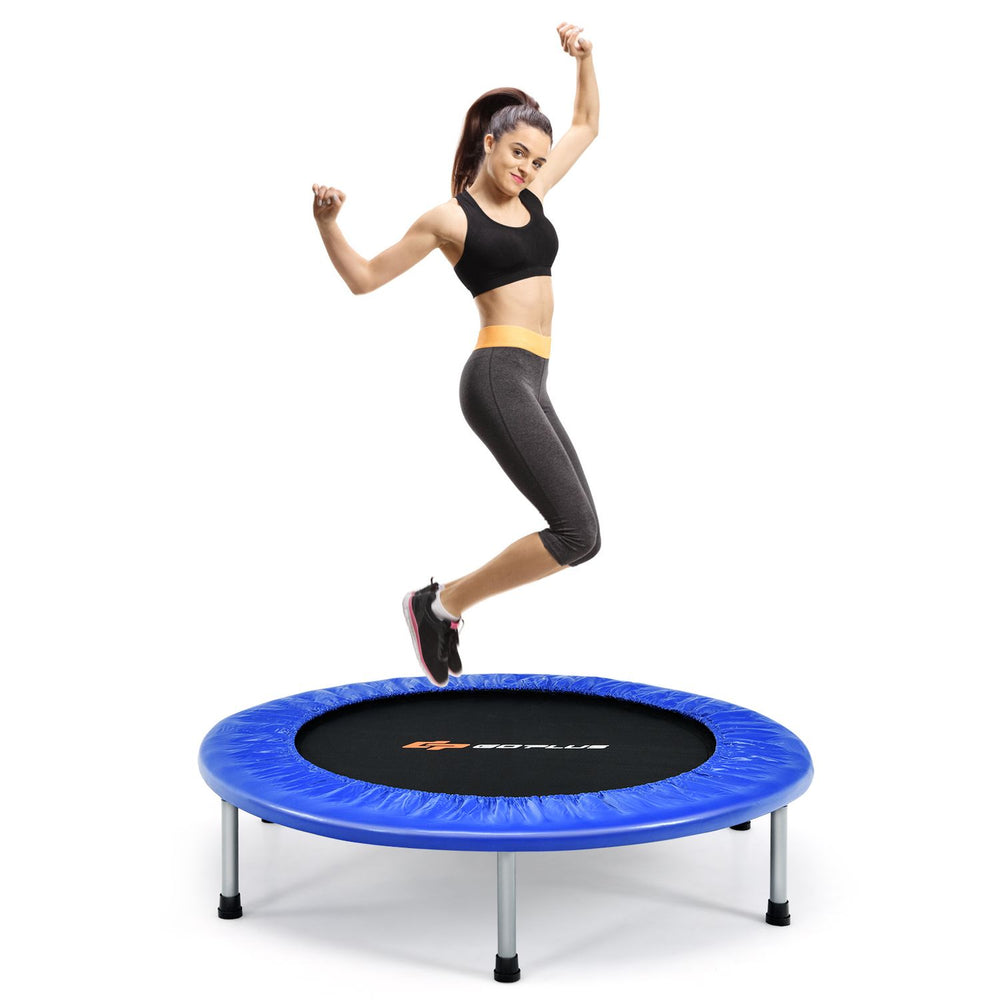 A woman jumps on a 40" foldable fitness trampoline with a blue safety pad, ideal for fun and exercise for all ages.