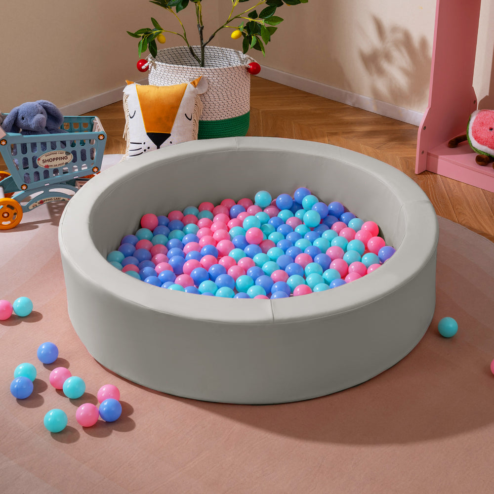 Round gray foam ball pit filled with vibrant ocean balls, designed for toddlers' indoor play and sensory stimulation.