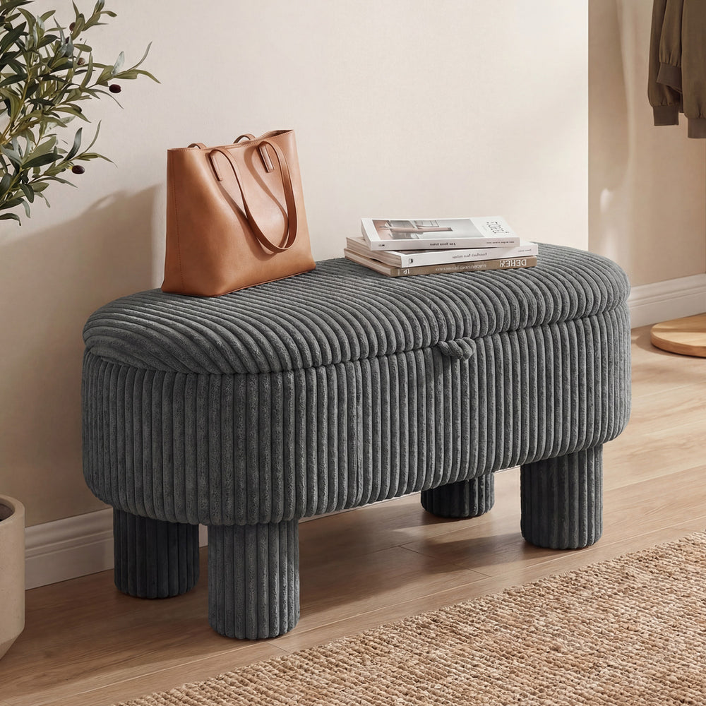 Gray corduroy storage ottoman bench with plush fabric and thick legs, perfect for seating and storage in any room.