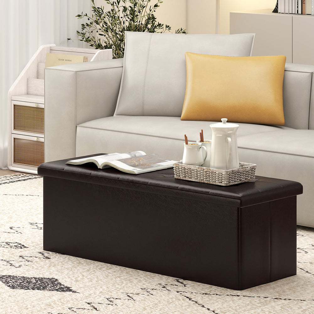 Brown folding storage ottoman bench with removable divider, 38-gal capacity, ideal for living room or bedroom use.
