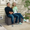 Outdoor storage bench with acacia wood lid, featuring a zippered liner, used as a seating area for patio relaxation.