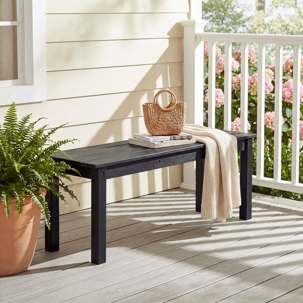 Black 45" outdoor HDPE bench with slatted seat design, suitable for patios and gardens, supports up to 660 lbs.