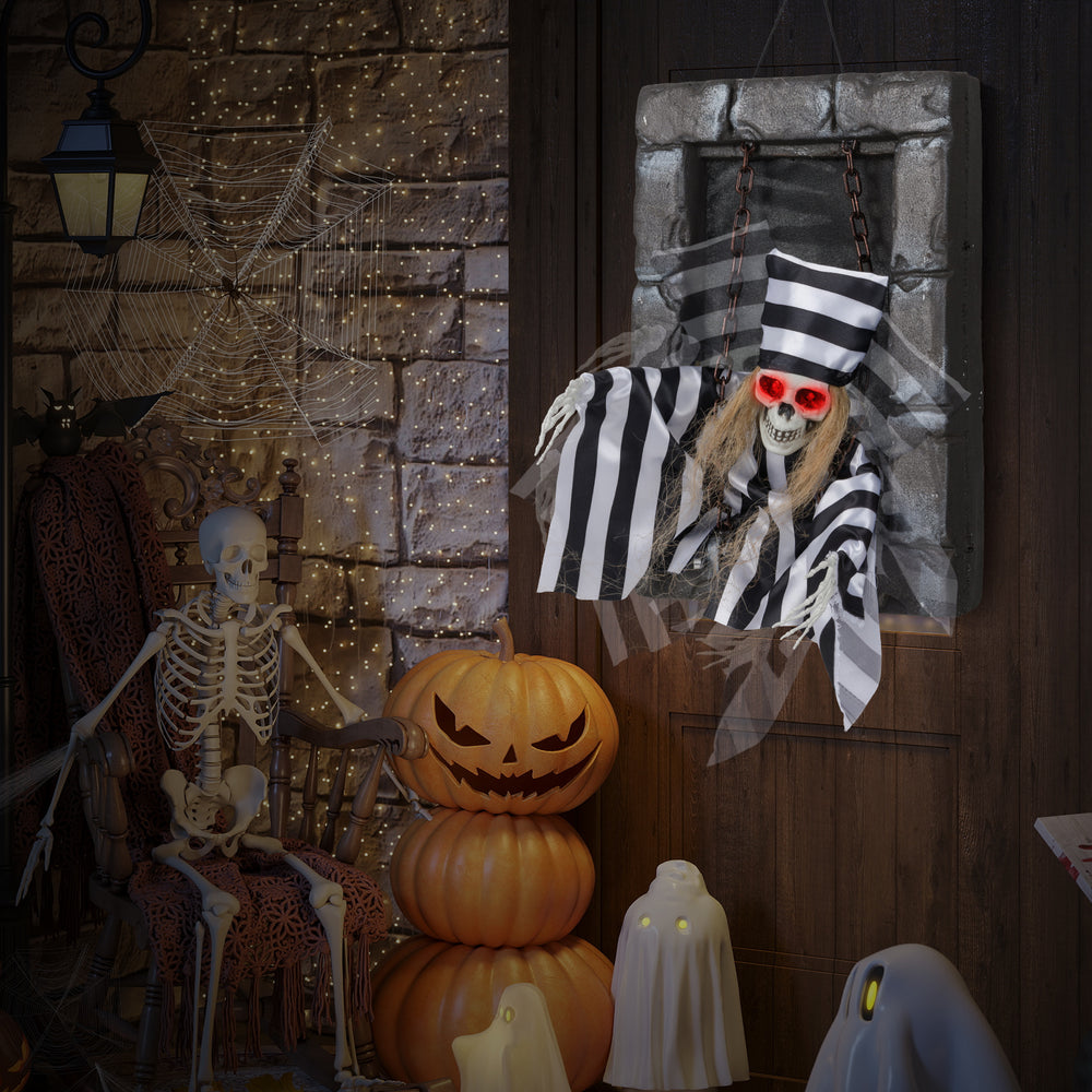 Animated 18-inch hanging skull prisoner decoration with sinister movements and light-up eyes, ideal for chilling.