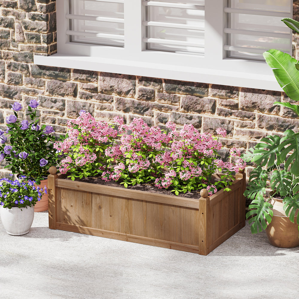 Rectangular brown planter box made of natural fir wood, featuring drainage holes, filled with pink flowers for garden.