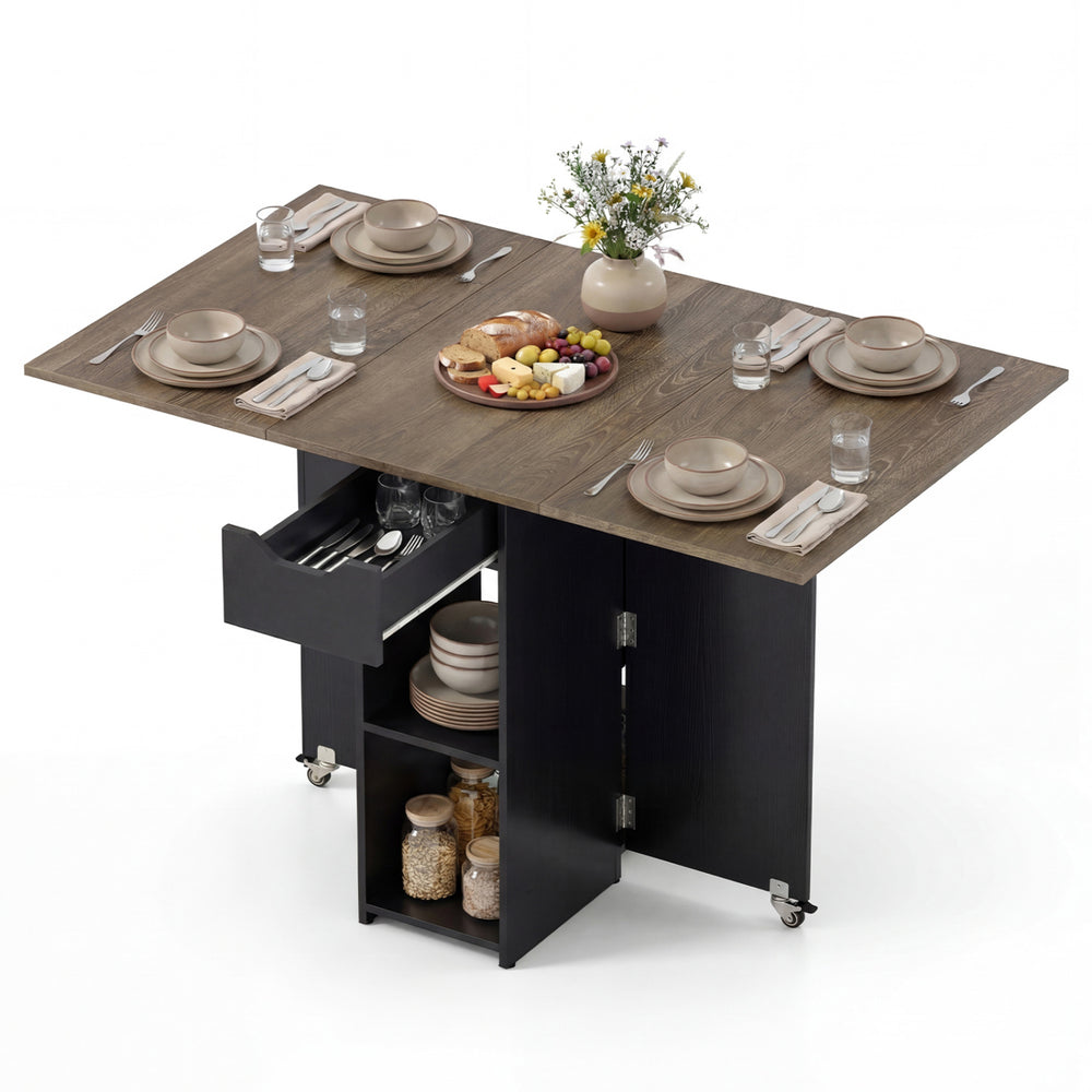 Extendable wooden dinner table with lockable wheels, featuring drop leaf panels, a drawer, and two shelves for storage.