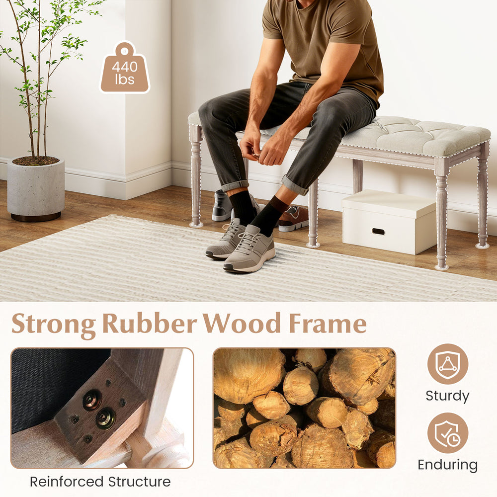 Upholstered bench with carved rubber wood legs, beige padded seat, and 440 lbs capacity for stylish entryway seating.
