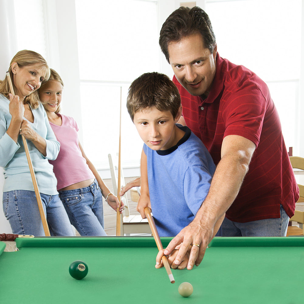 Family enjoying a game at the 47-inch green folding billiard table, enhancing kids' hand-eye coordination and logical.