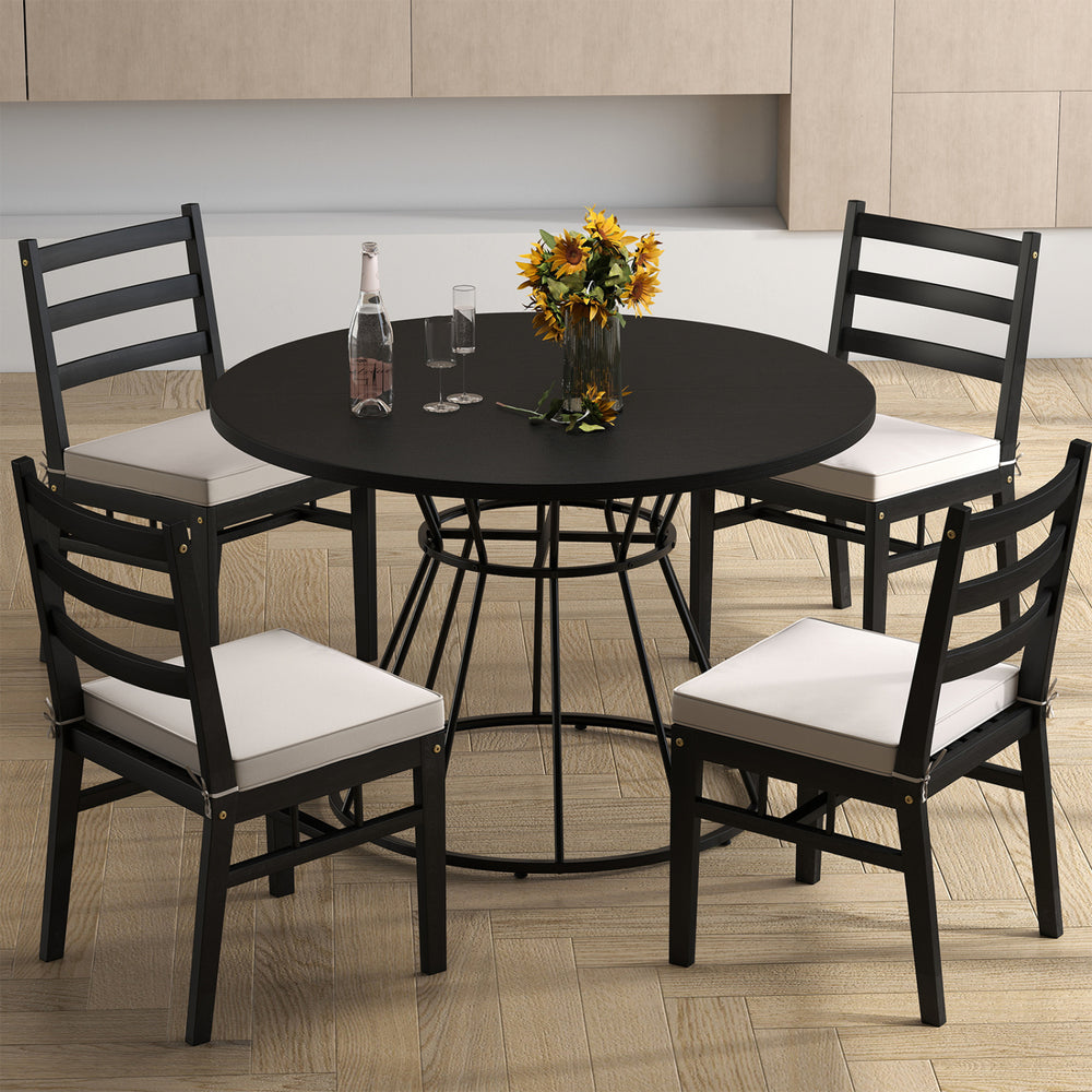 Round 47-inch black dining table with wooden tabletop and four chairs, perfect for kitchen or dining room gatherings.