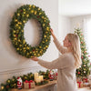 Large 48-inch pre-lit artificial Christmas wreath with 150 warm white LED lights and realistic pine cones for festive decor.
