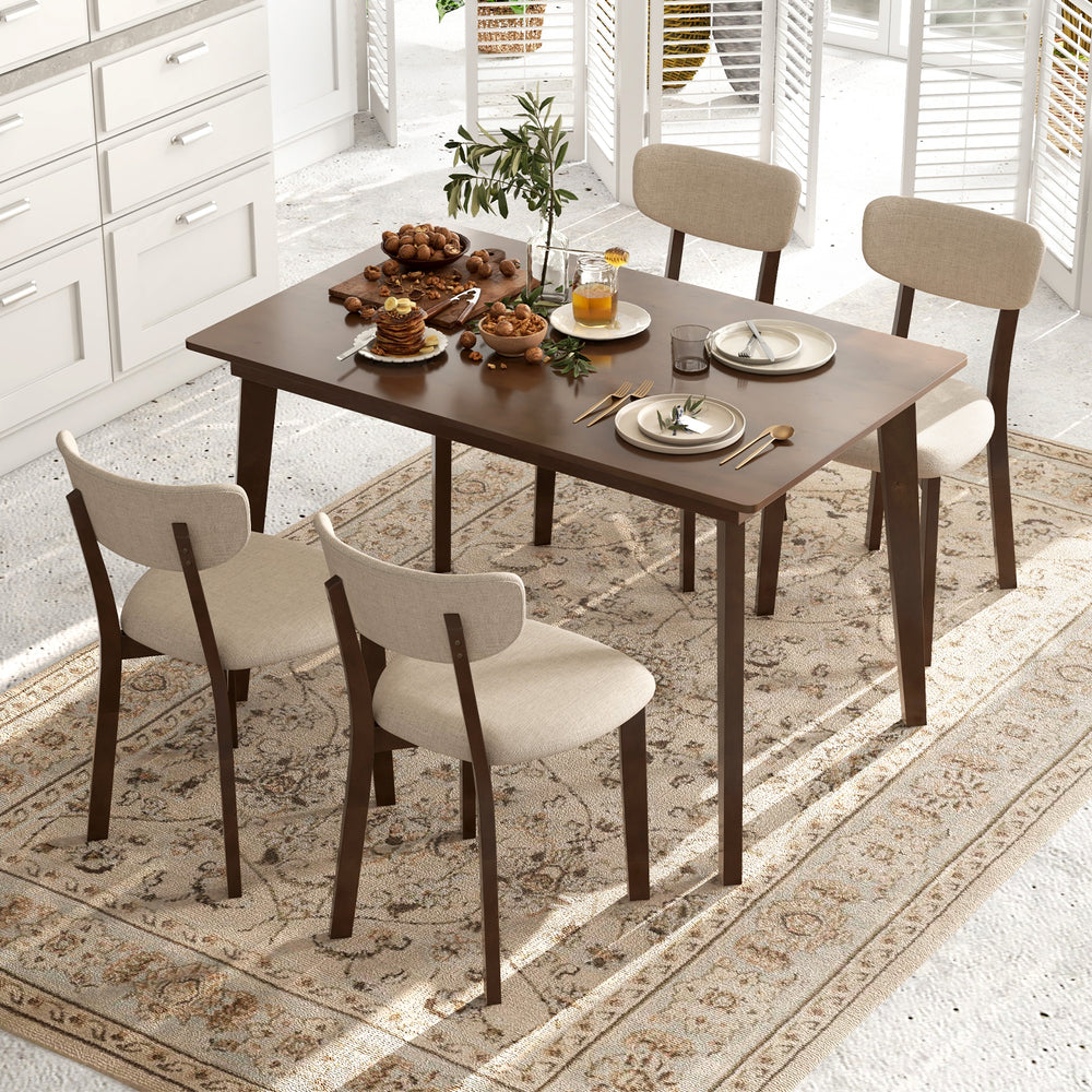 48-inch wooden dining table with rubber wood legs, set for four, ideal for dining or studying in small spaces.