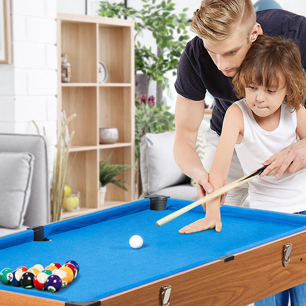Child and adult playing on a 48-inch 3-in-1 game table featuring billiards, soccer, and hockey for family fun.