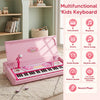 Kids electric piano keyboard toy in pink with 49 keys, microphone, stool, and multiple sound modes for interactive play.