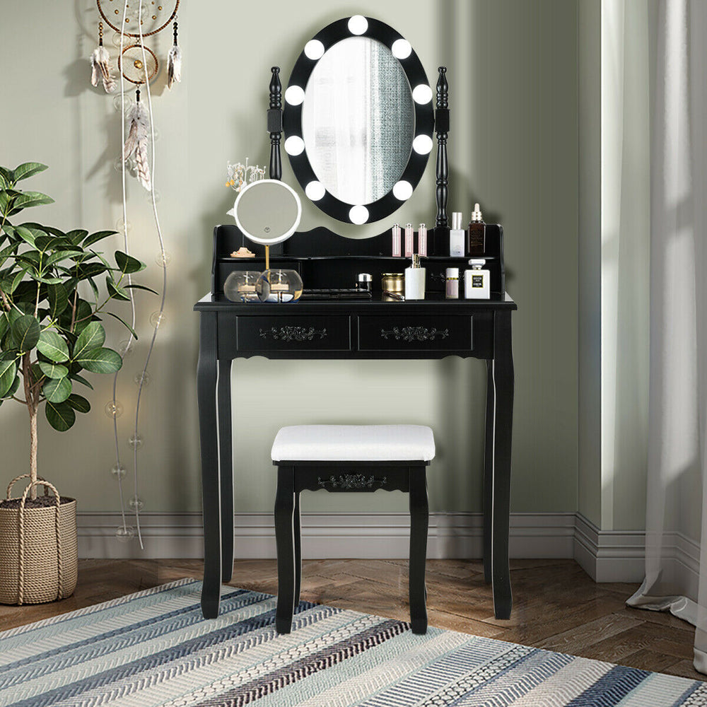 Black makeup dressing table with lighted mirror, cushioned stool, and ample storage for cosmetics in an elegant design.