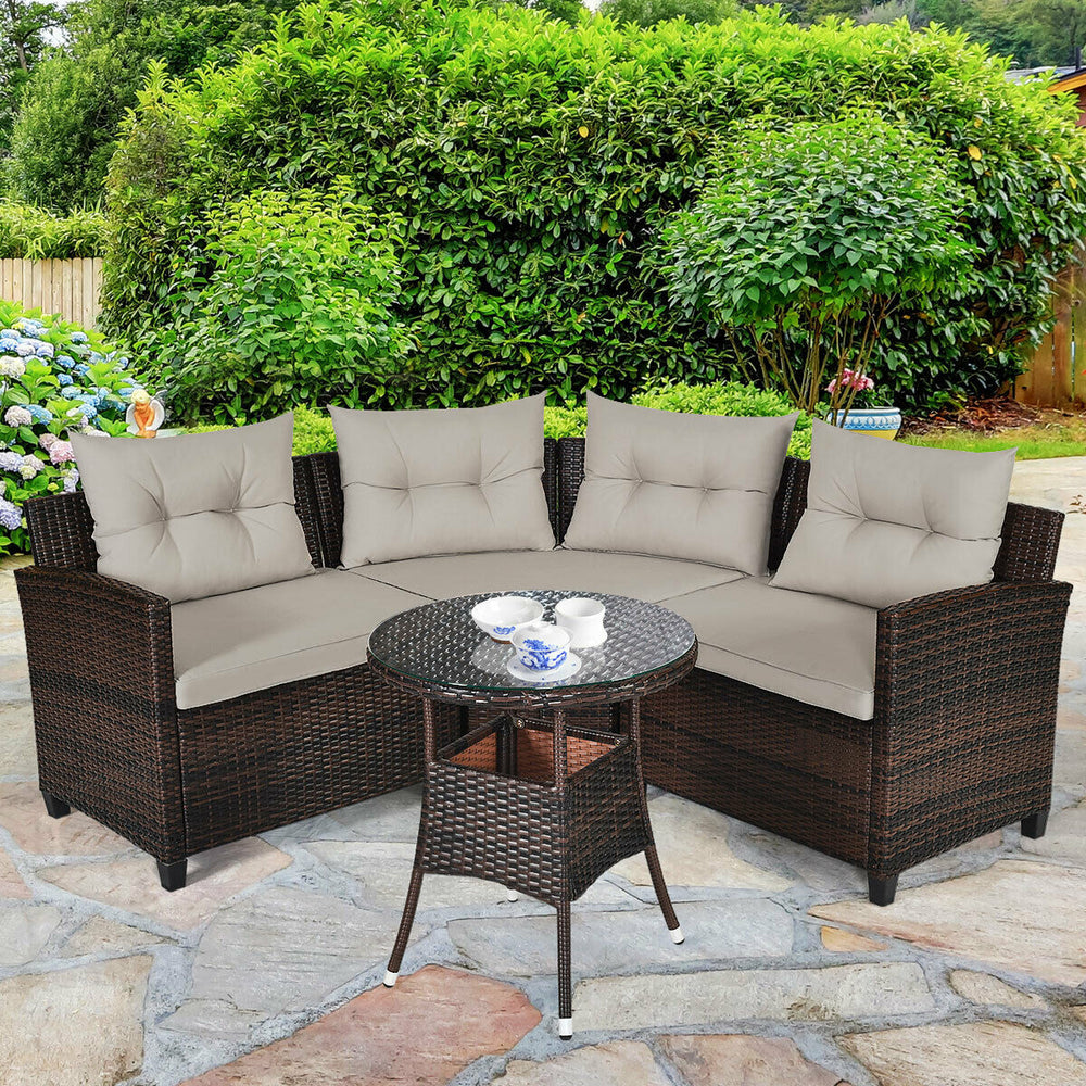Outdoor wicker sofa set with soft cushions and coffee table, perfect for garden or patio relaxation.