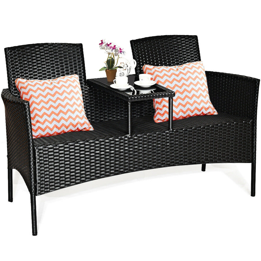 Wicker patio conversation set featuring removable cushions, a glass table, and ergonomic design for outdoor relaxation.