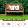 Two-person solid wood garden bench with curved backrest and wide armrest, featuring a natural teak color for outdoor.