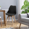 Mid-century modern dining chair with black PU seat and beech wood legs, perfect for kitchen or living room gatherings.