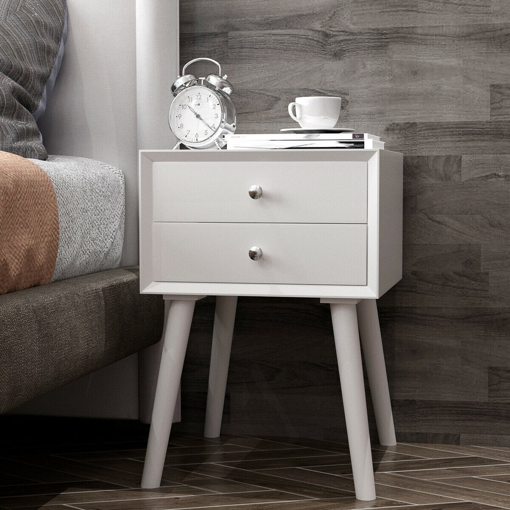 Mid-century white wooden nightstand with two storage drawers, perfect for bedside decor and efficient space use.