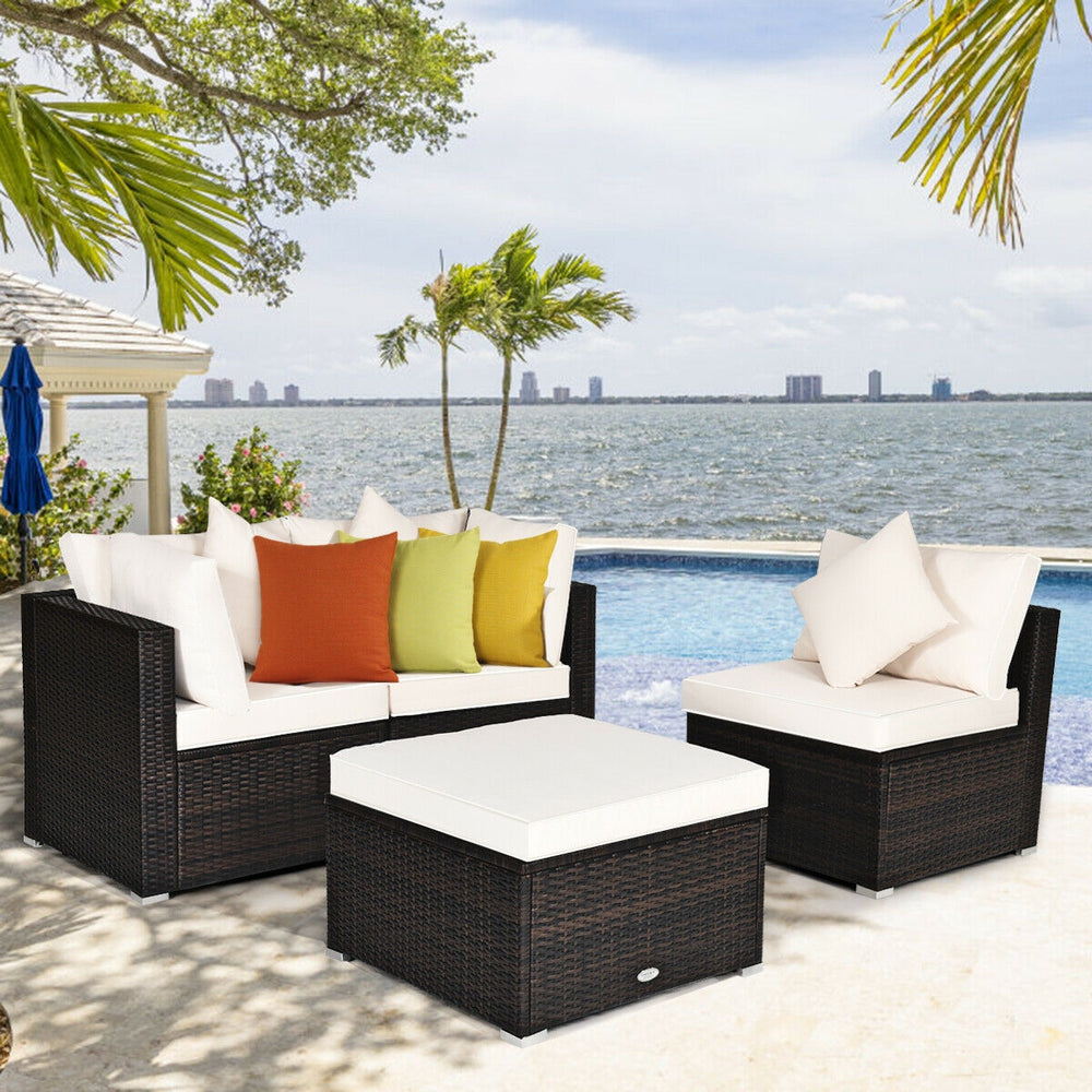 4-piece rattan wicker patio furniture set with cushioned sofas and ottoman, perfect for outdoor relaxation.