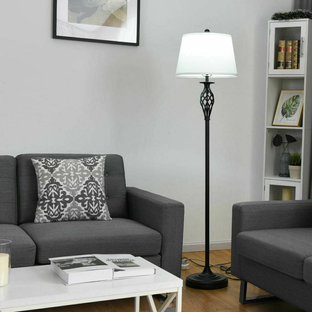 Floor lamp with white fabric shade and metal base, perfect for traditional decor in living room or bedroom.