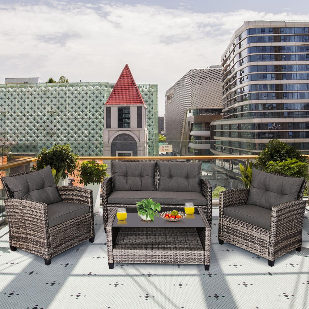 4-piece patio rattan furniture set with gray cushions, including loveseat, two single sofas, and coffee table for.
