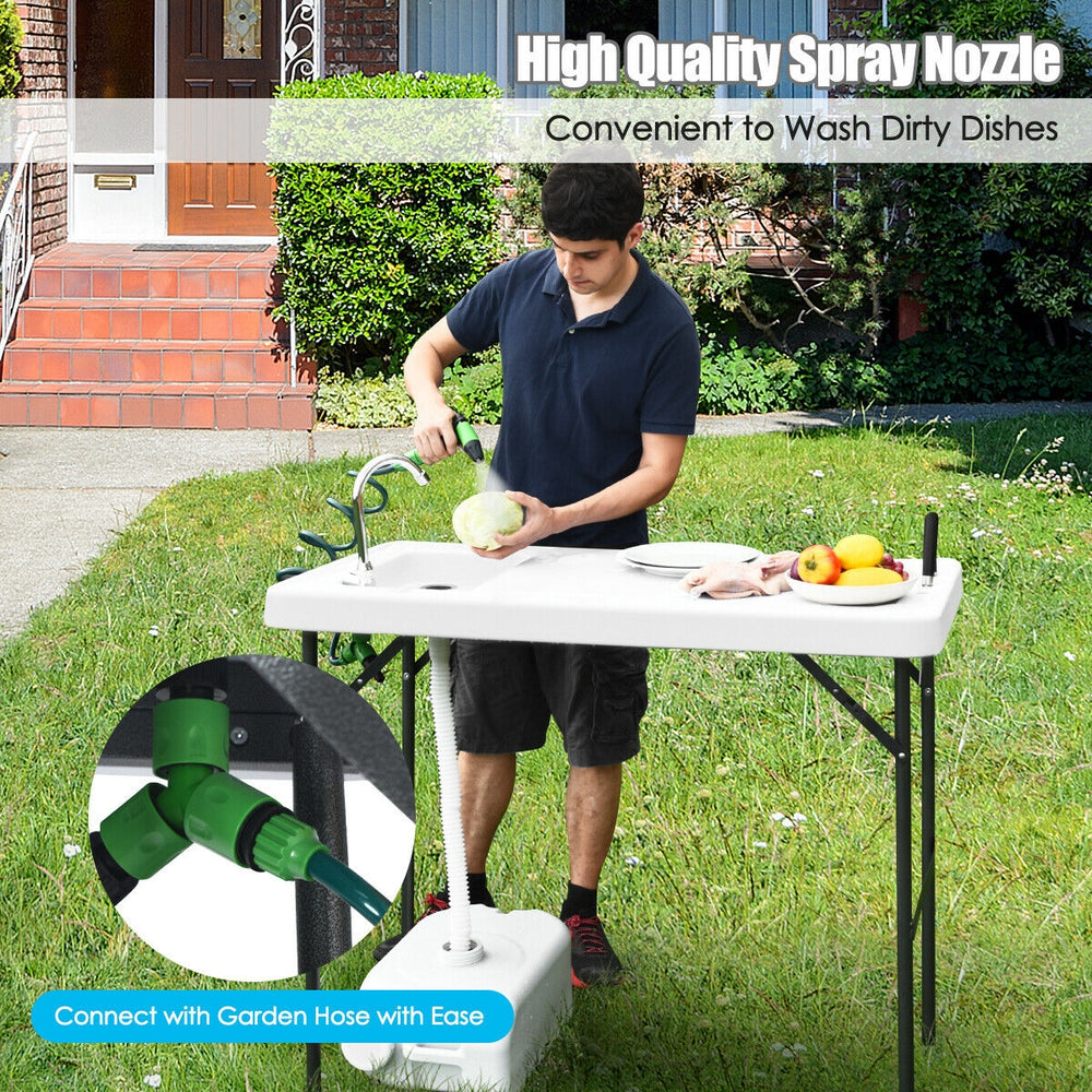 Folding cleaning sink table with sprayer, quick-connect faucet, and integrated drain for outdoor cleaning convenience.