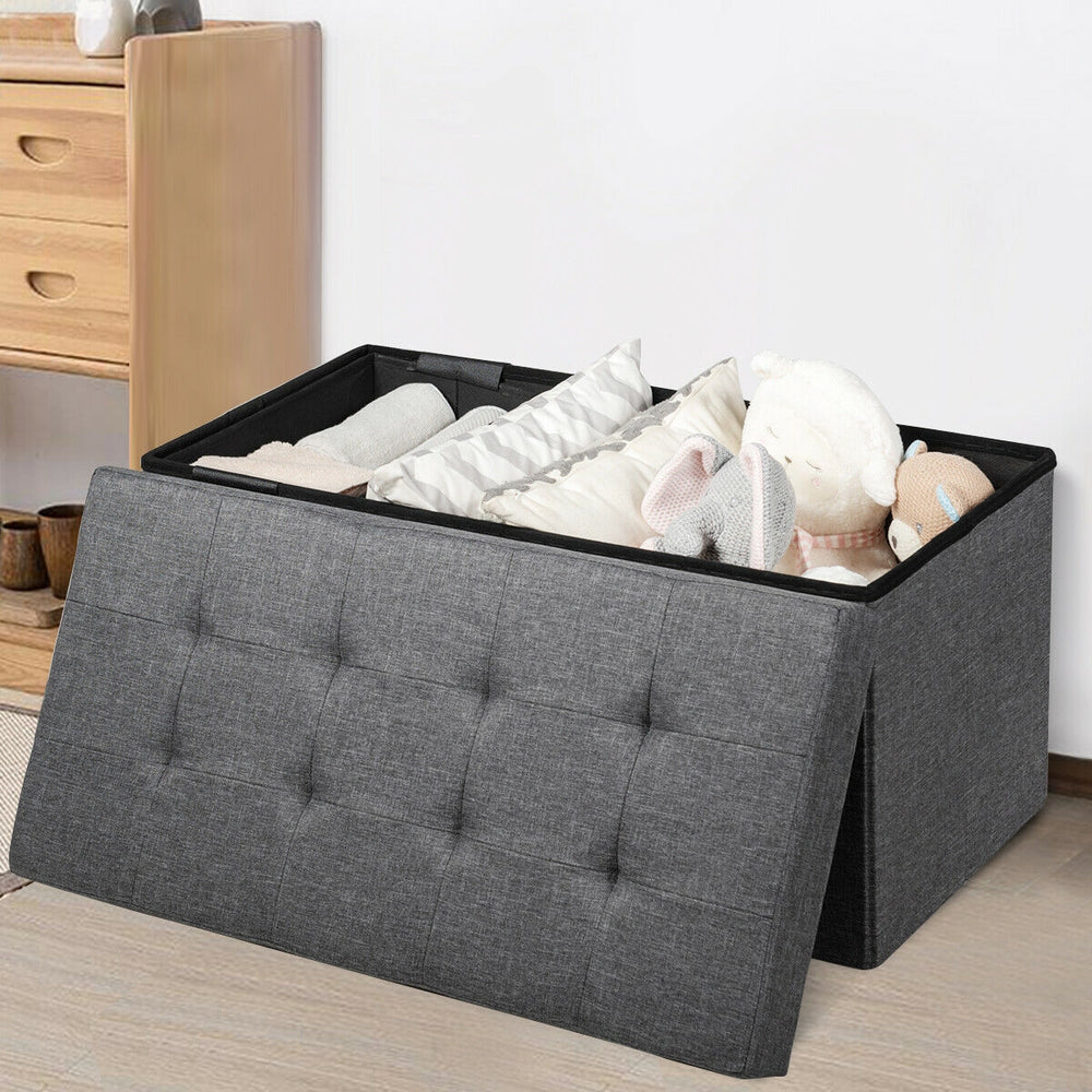 Foldable dark gray storage ottoman with padded seat and roomy interior for blankets, clothes, and toys, ideal for any.