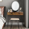 Rustic brown stool with soft cushion, part of the industrial makeup dressing table set for comfortable seating.