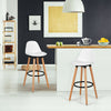 Armless mid-century barstool in white with padded seat and beech wood legs, perfect for stylish kitchen or bar settings.