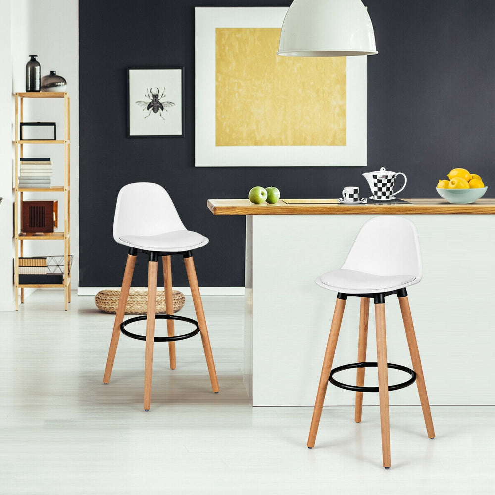 Armless mid-century barstool in white with padded seat and beech wood legs, perfect for stylish kitchen or bar settings.