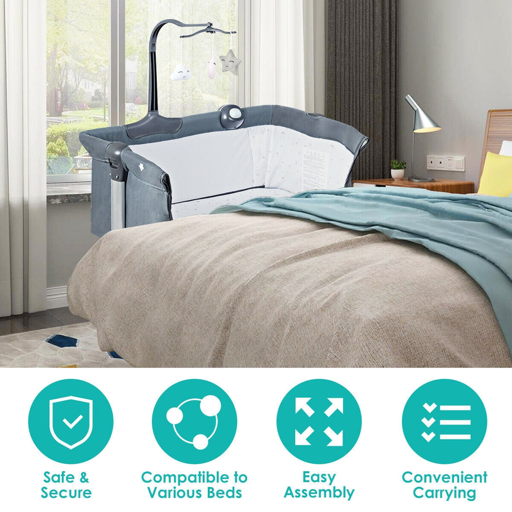 Height adjustable baby side crib in dark gray with toy rack and music box, perfect for co-sleeping and nighttime care.