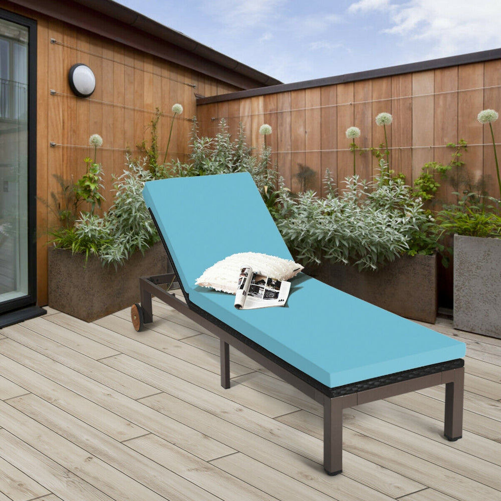 Turquoise outdoor rattan chaise lounge chair with adjustable backrest and soft cushion, perfect for sunbathing on.