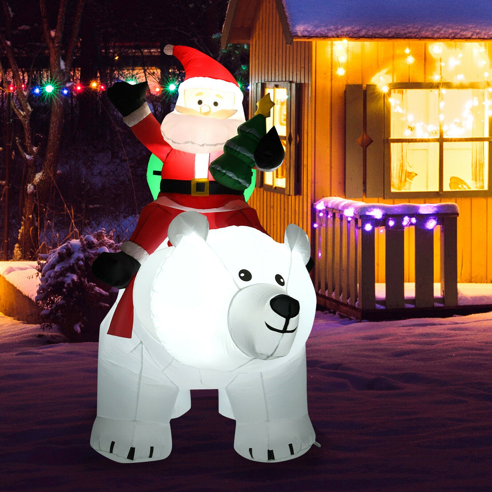 Christmas inflatable Santa riding a polar bear with LED lights, perfect for festive home and yard decoration.