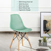 Single green DSW dining chair with beech wood legs, ergonomic mesh seat design for comfort and style in any space.