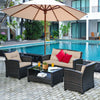 4-piece outdoor rattan furniture set featuring a loveseat, two single sofas, and a glass table, perfect for backyard.