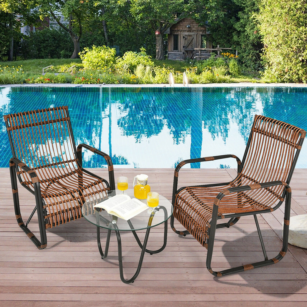 Patio rattan furniture set featuring 2 wicker chairs and a glass side table, perfect for outdoor relaxation by the pool.