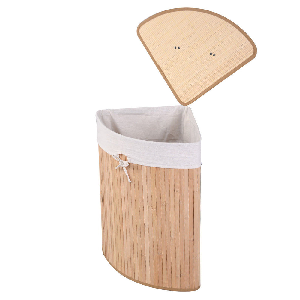 Corner bamboo laundry hamper with a natural finish, featuring a removable liner and PU leather handles for easy.