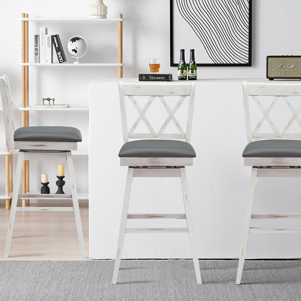 Set of 2 white swivel counter height barstools with rubberwood legs and gray PVC leather cushions for versatile seating.