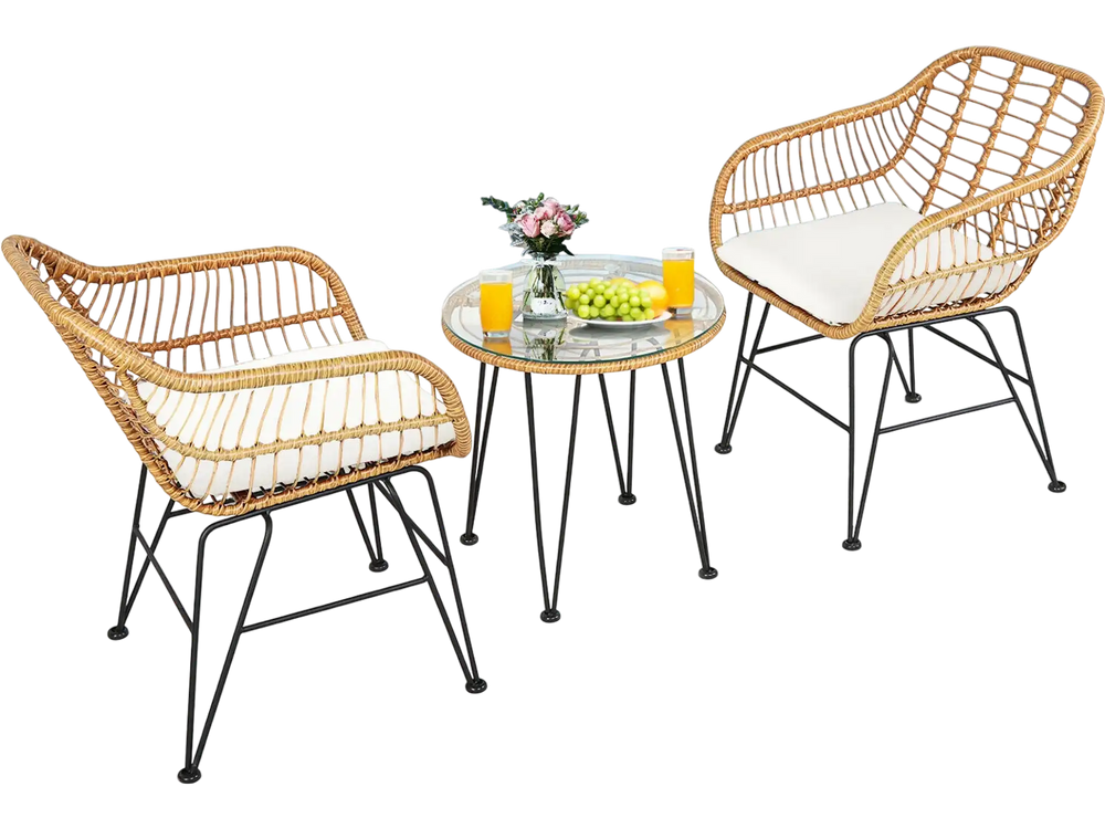 Two cushioned rattan chairs and a round glass-top table, perfect for outdoor patio relaxation and entertaining.