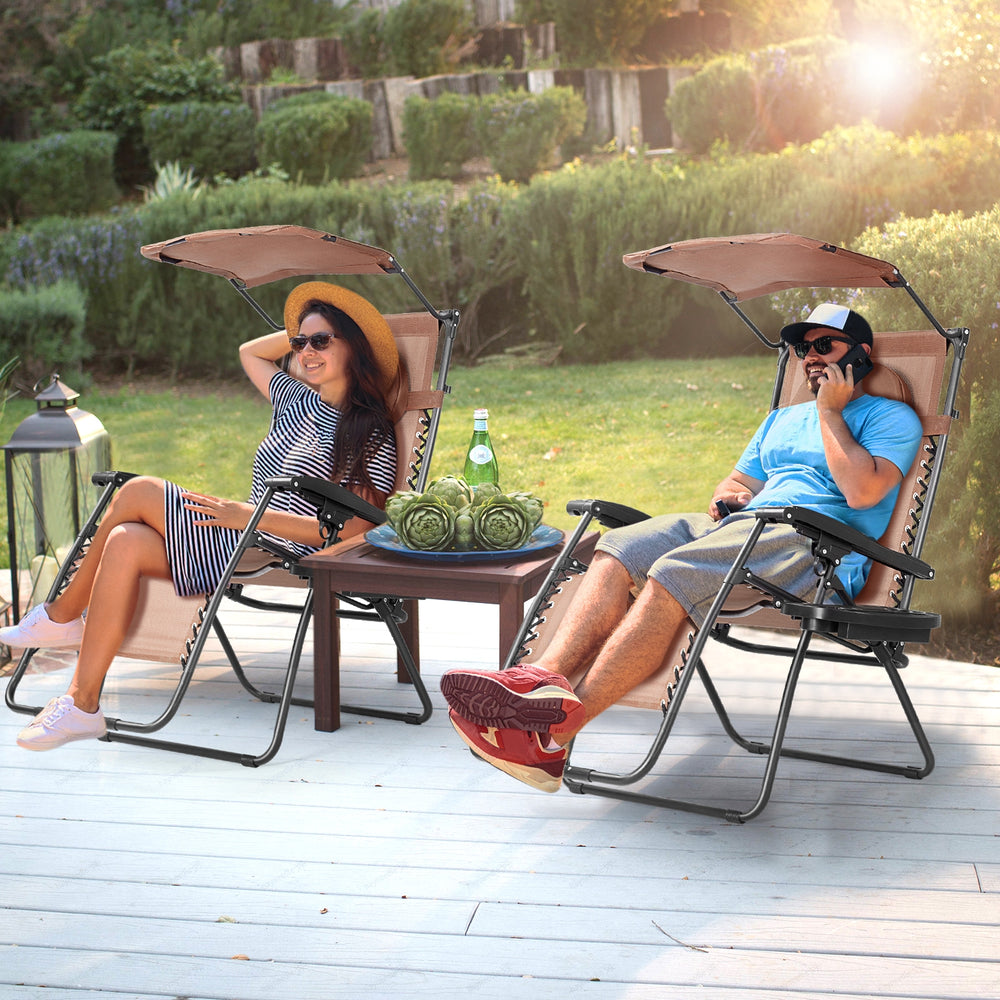 Folding recliner lounge chair with shade canopy and cup holder, perfect for outdoor relaxation in brown.