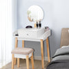 Wooden makeup dressing table set with round mirror, drawer, and cushioned stool, perfect for organizing beauty items.