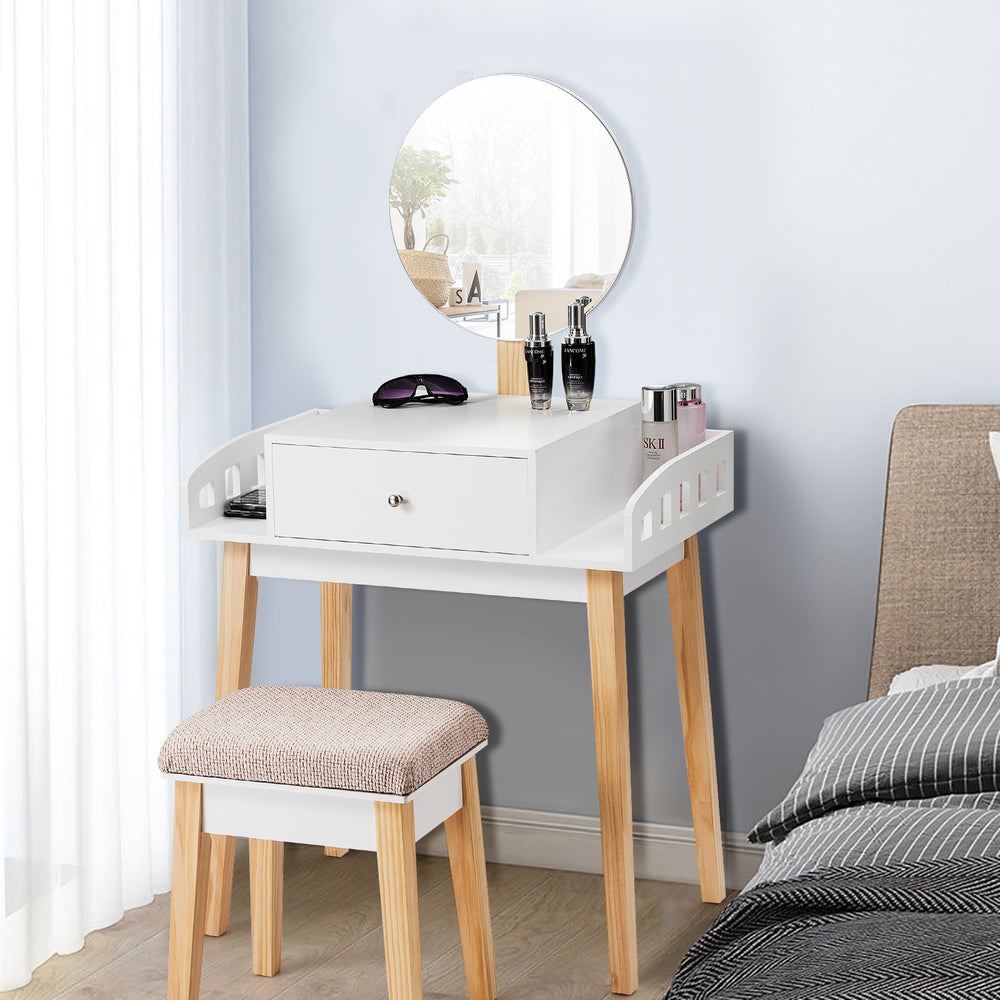 Wooden makeup dressing table set with round mirror, drawer, and cushioned stool, perfect for organizing beauty items.