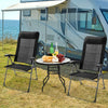 Two portable black patio folding dining chairs with adjustable headrests, set up for outdoor dining by a camper.